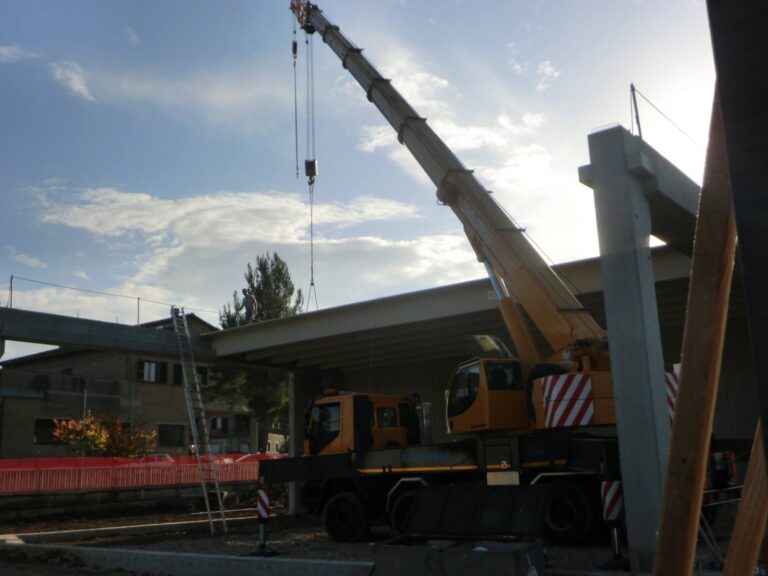 Gru cantiere edile con operai su struttura.